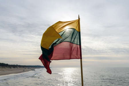 Lithuanian flag in wind at coast of Lithuania.の写真素材