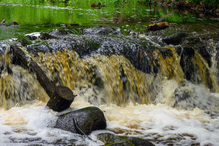 Rapid water stream in waterfall on small river.の写真素材