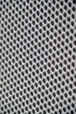 Metalic gray painted mesh with round holes.の写真素材