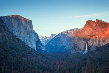 Colorful sunset in Yosemite valley, tunnel view to the dome and El capitan and tall waterfallの写真素材