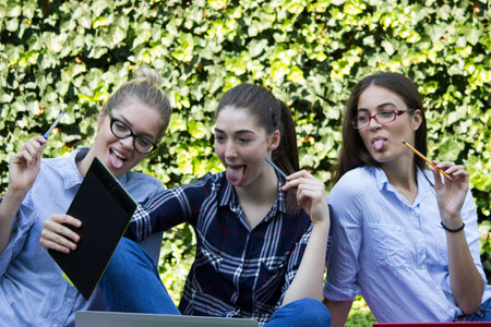 happy students looking at tabletの写真素材