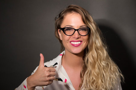 Beautiful young woman showing thumb