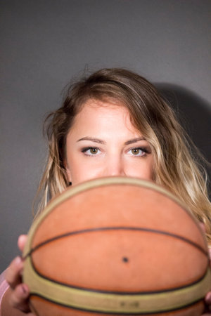 girl holding basketball ballの写真素材