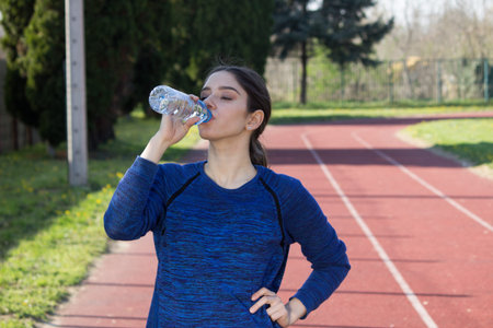 active young girl drinking water