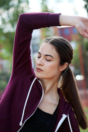beautifull young girl stretching after workoutの写真素材
