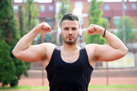 young man showing musculeの写真素材