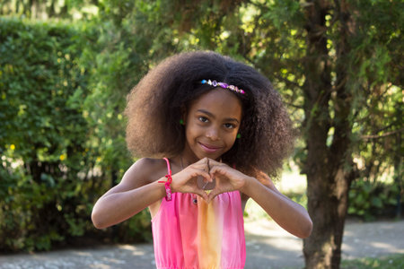 Mixed little girl sending love