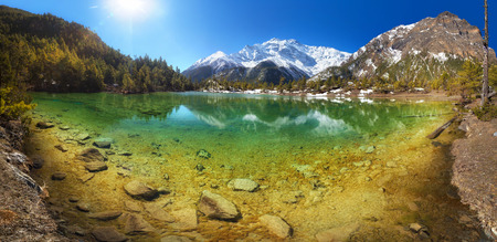 Beautiful mountain lake with crystal clear water surrounded by hills and mountains. Nepal Annapurna region Mring lake 3270 m and Annapurna II 7937 mの写真素材