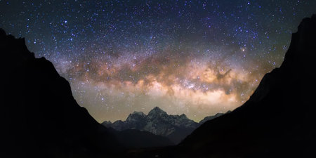 Bright and vivid Milky Way galaxy over the snowy mountains. Beautiful starry night sky seems to be in a "bowl" between the silhouetted hills.の写真素材