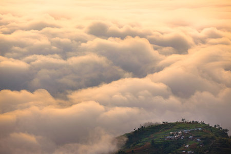 View of the sea of clouds around a small island of land.
