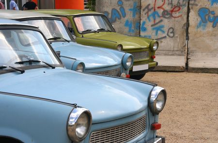 East-German cars parked near a stretch of Berlin wallの写真素材