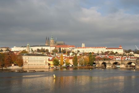 Prague in autumn, with castle and cathedral, across the Moldau with backdrop of raincloudsの写真素材
