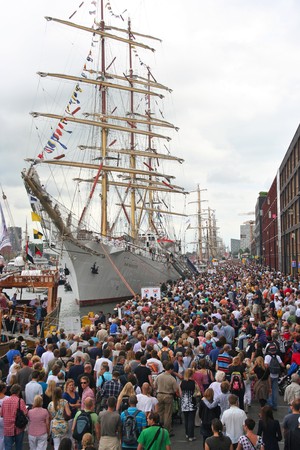 AMSTERDAM, AUGUST 19, 2010: Crowds on the quay admire the tall ships at Sail 2010 in Amsterdam, Holland on august 19, 2010