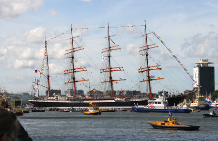 AMSTERDAM, AUGUST 19, 2010: Russian tall ship Sedov being turned round by tugboats at Sail 2010 in...