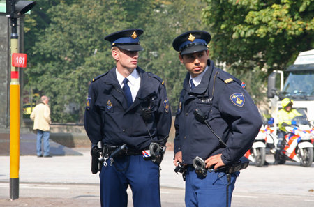 THE HAGUE, HOLLAND - SEPTEMBER 21, 2010: Young police officers watching the crowd at the Parliament...