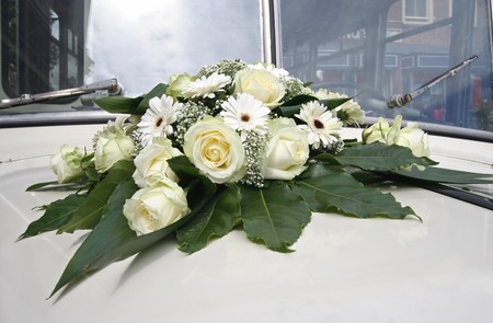 Bridal bouquet on wedding limousineの写真素材