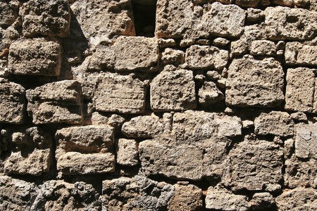 Ancient stone wall of a house in Greeceの写真素材