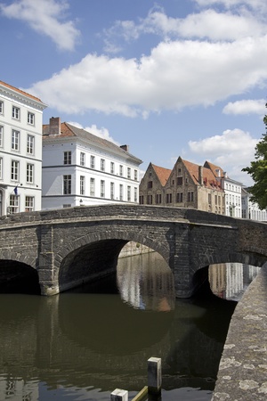 Stone bridge across a canal in the historical center of Bruges, Belgiumの写真素材