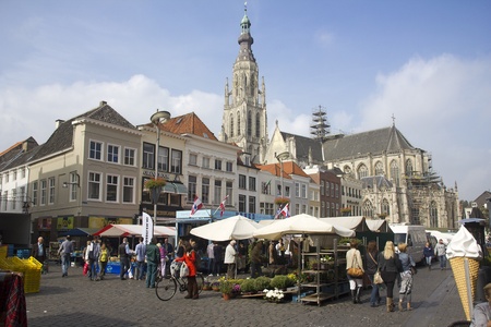 Breda, Holland - September 23, 2011: People shopping in the market in Breda, Holland, with the cathedral in the backgroundのeditorial素材