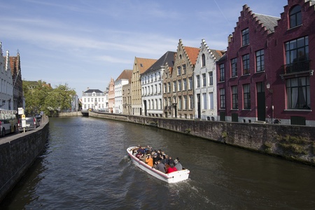Bruges, Belgium - May 4, 2011: Boat with tourists in a canal in Bruges, Belgium on May 4, 2011のeditorial素材