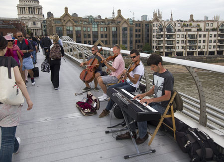 London, UK - July 25, 2011: Musicians play on Millennium Bridge in London on July 25, 2011 in...