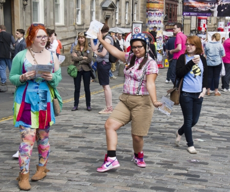 EDINBURGH, UK: AUGUST 2: Girls hand out flyers on the Edinburgh Festival Fringe in Edinburgh, UK on August 2, 2012のeditorial素材