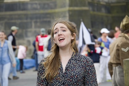 EDINBURGH: AUGUST 2: Lily de-la-Haye of The Picture House musical cast of Play Pen Productions sings on the Royal Mile, the main street of Edinburgh, at the Edinburgh Festival Fringe on August 2, 2012 in Edinburgh.のeditorial素材