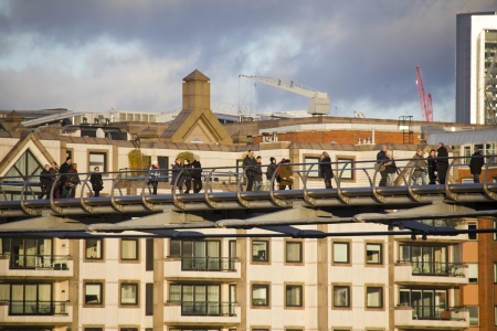London, UK - January 1, 2013: People walk across the Millennium Bridge across the Thames in London, UK on January 1, 2013のeditorial素材