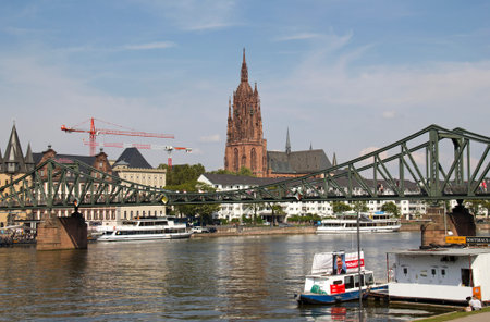 Frankfurt, Germany - August 29, 2013  The iron footbridge across the Main river and floating cafes in Frankfurt, Germany on August 29, 2013 のeditorial素材