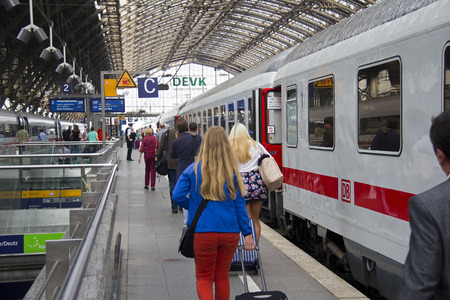 Cologne, Germany - August 30, 2013  People with luggage walk to an international train on a platform in the historic railway station of Cologne, Germany on August 30, 2013のeditorial素材