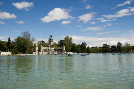 Madrid, Spain - May 29, 2016: People boating in the pond of El Retiro park in Madrid, Spain on May...