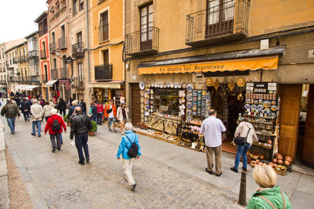 Segovia, Spain - May 30, 2016: People walking past a souvenir shop in a historical street in Segovia, Spain on May 30, 2016のeditorial素材