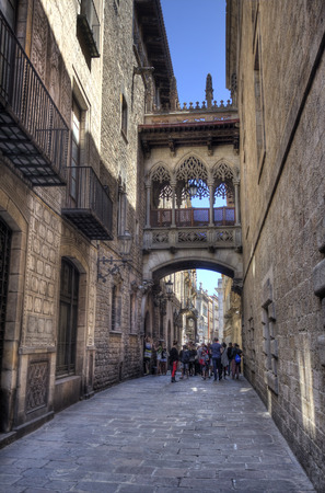 Barcelona, Spain - May 22, 2015: A group of schoolchildren under the bridge in Del Bisbe street in the Gothic Quarter in downtown Barcelona, Spain on May 22, 2015.のeditorial素材