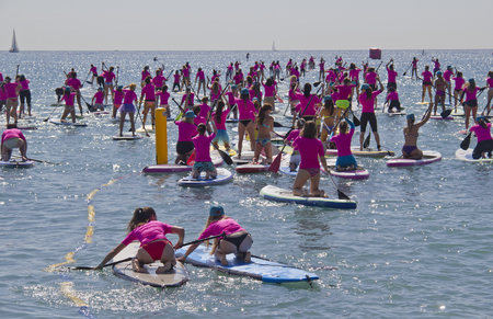 Barcelona, Spain - May 23, 2015: Girls with surfboards paddle out to sea from the beach in Barcelona, Spain on May 23, 2015.のeditorial素材