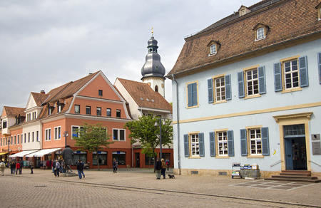 Speyer, Germany - May 2, 2014: Tourists walk in the mainstreet flanked with historical buildings and church towers in the old centre of Speyer, Germany on May 2, 2014のeditorial素材