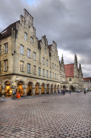 Munster, Germany - December 22, 2015: Shops on Prinzipalmarkt street with people walking in the early morning in winter in Munster, Germany on December 22, 2015のeditorial素材