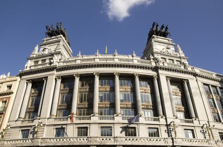 Facade of the Banco de Bilbao building with statues on the roof on Calle de Alcala in Madrid, Spainのeditorial素材