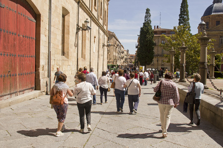 Salamanca, Spain - June 2, 2016: Group of tourists admire the historical buildings of the Salamanca university in Calle Rua Mayor street in the old center of Salamanca, Spain on June 2, 2016のeditorial素材