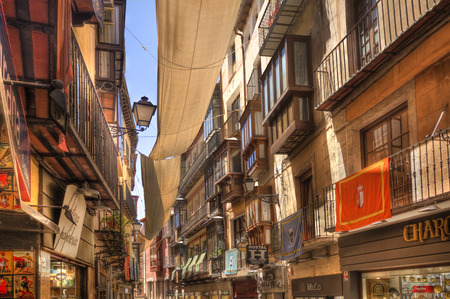 Toledo, Spain - June 1, 2016: Shops and other buildings in a historical street in central Toledo, Spain on June 1, 2016のeditorial素材