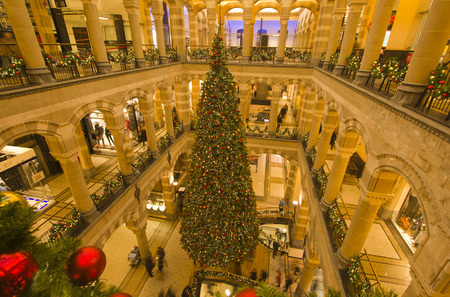 Amsterdam, Holland - December 28, 2015: Large Christmas tree and people shopping in a fashionalble shopping mall in Amsterdam, Holland on December 28, 2015のeditorial素材