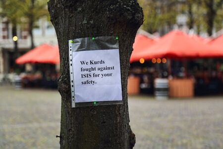 The Hague, The Netherlands - October 28, 2017: Message with the text: We Kurds fought against ISIS for your safety, pinned to a tree by a Kurdish demonstration in The Hague, The Netherlands on October 28, 2017のeditorial素材