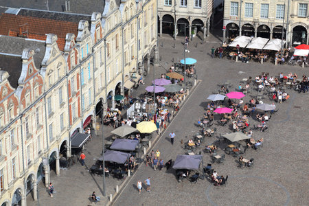 Arras, France - May 28, 2017: People sit at restaurants in historical Flemish style houses on the...