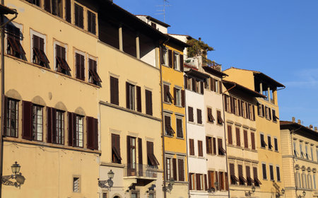 Typical historical houses with shutters for the windows in a street in the old part of Florence, Italyの写真素材