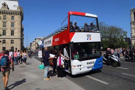 Paris, France - May 19, 2018: Tourists enter a tourist bus near Notre Dame cathedral in Paris, France on May 19, 2018のeditorial素材