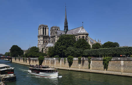 Paris, France - May 19, 2018: Tour boat, tourists and Notre Dame cathedral in Paris, France on May 19, 2018のeditorial素材