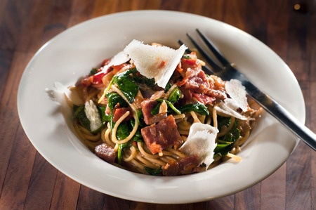 Spinach tomato salami pastaの写真素材