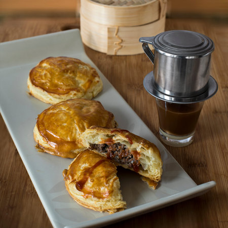Traditional Vietnamese puff pastry meat pies  (banh pate so bo nam va dau hoa lan)