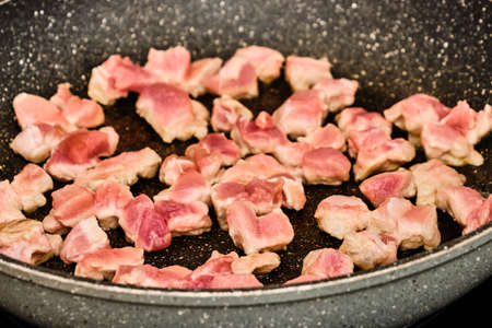 Cooking raw pork meat on frying panの写真素材