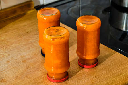 Finished tasty homemade marmelade in glass with bottom on top on wooden tableの写真素材