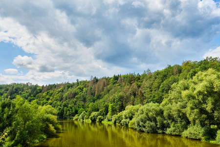 View on Sazava river with reflections surrounded by forest by Zboreny Kostelec near Tynec nad Sazavou, Czechの写真素材